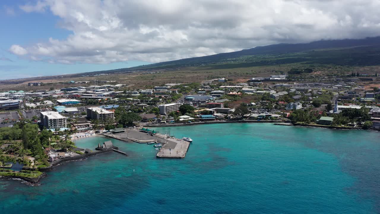 Aerial wide panning shot of Kailua Bay nestled along historic Kona Town on the Big Island of Hawai'i