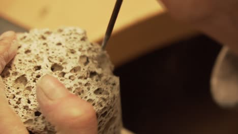 Crumbling-concrete-cylinder-with-rounded-file---close-up-shot-in-slowmo