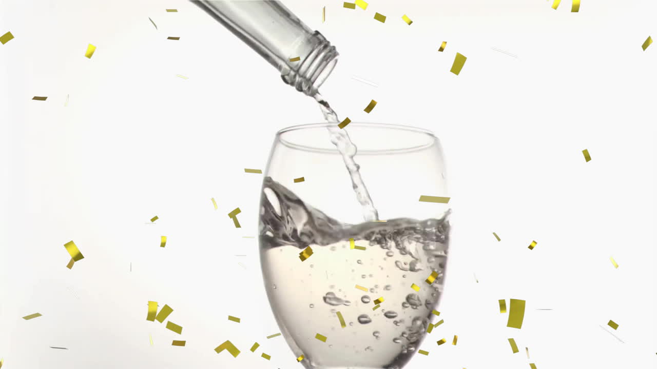 Animation of confetti over glass of white wine on white background