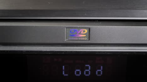 dvd player. disc installation. man plays dvd, cd on a player. front, top view. static shot.