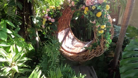 static view of a decorative wreath among green foliage
