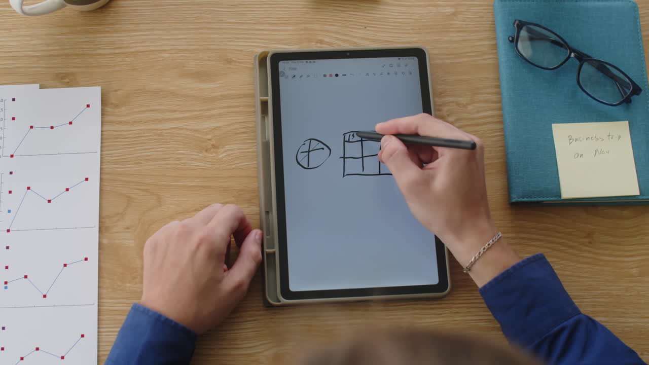 Top View of Hands of Person Drawing Sketch on Tablet