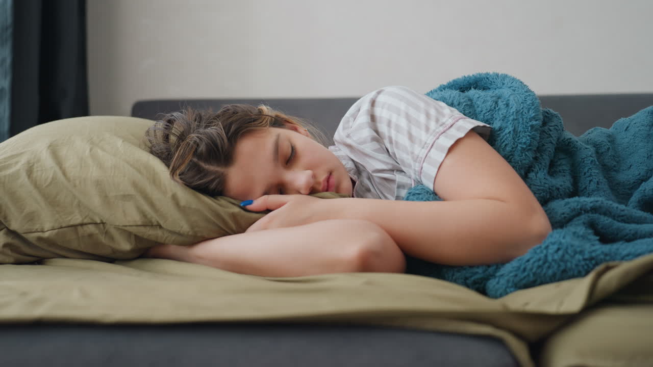 Lady Sleeps Serenely On Couch, Feminine Figure Taking Calm Nap Under Gentle Lighting Surroundings, Young Lady Comfortably Dozing On Sofa With Soft Illumination Creating Tranquil Atmosphere