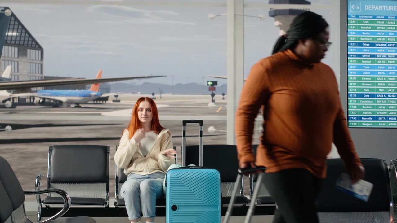 Multiethnic people walking in crowded airport terminal hallway during holiday rush