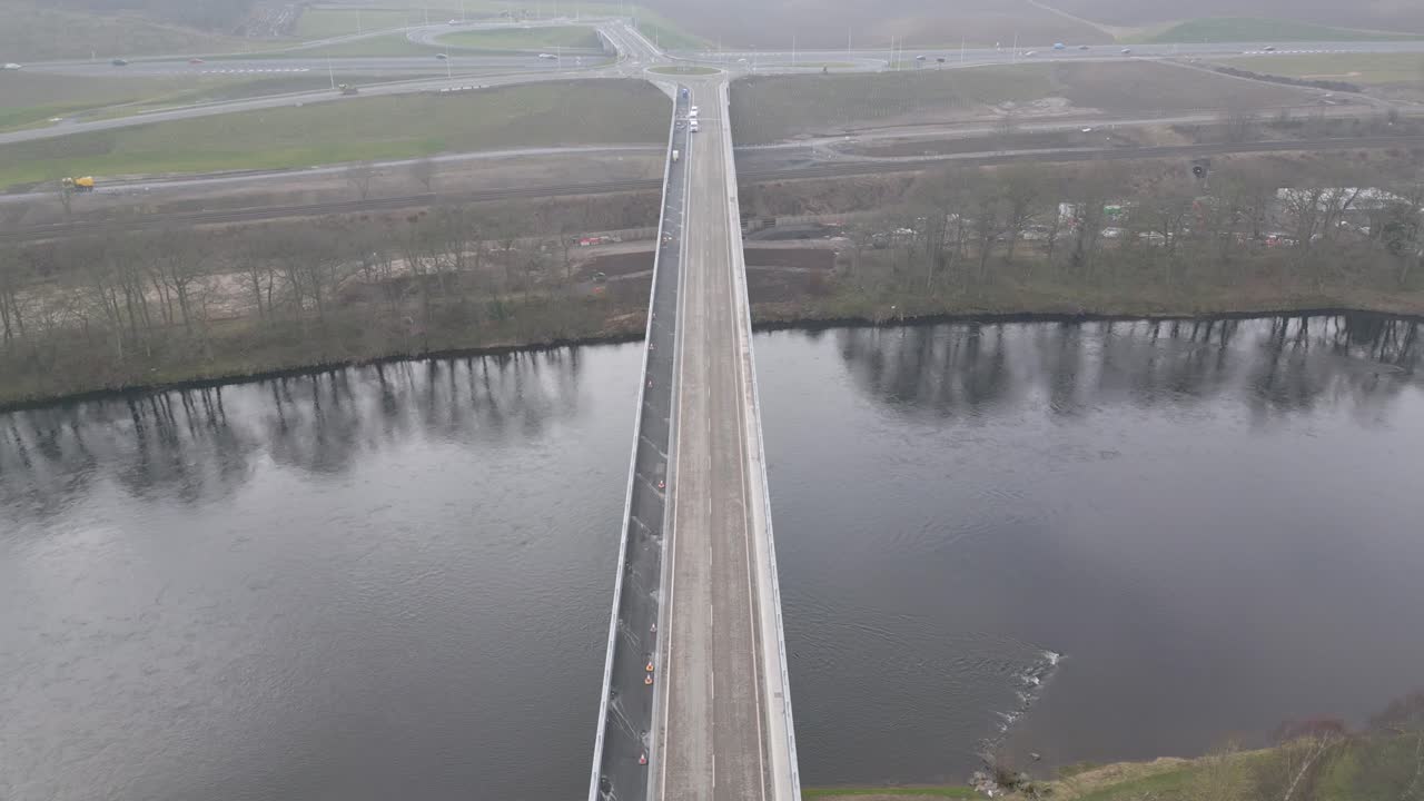 Bird's eye view of the new Destiny Bridge across River Tay before opening day. Drone ascending camera tilting down.