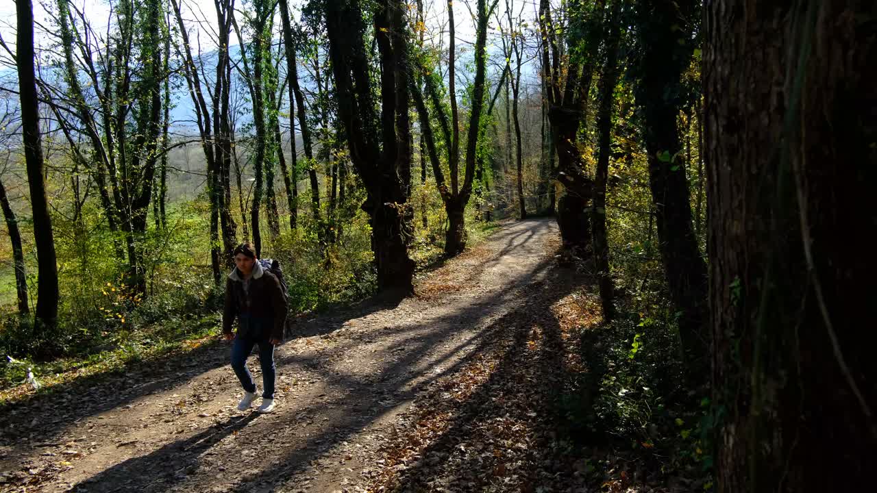 Camper Man in Autumn Forest