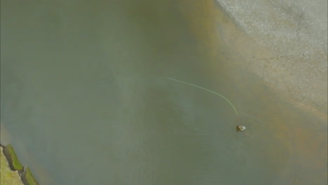 A-lone-fly-fisherman-casting-off-in-a-large-river-in-Argentina