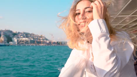 Slow-Motion:Beautiful-girl-enjoys-moment-while-cruising-with-view-of-sea-on-background