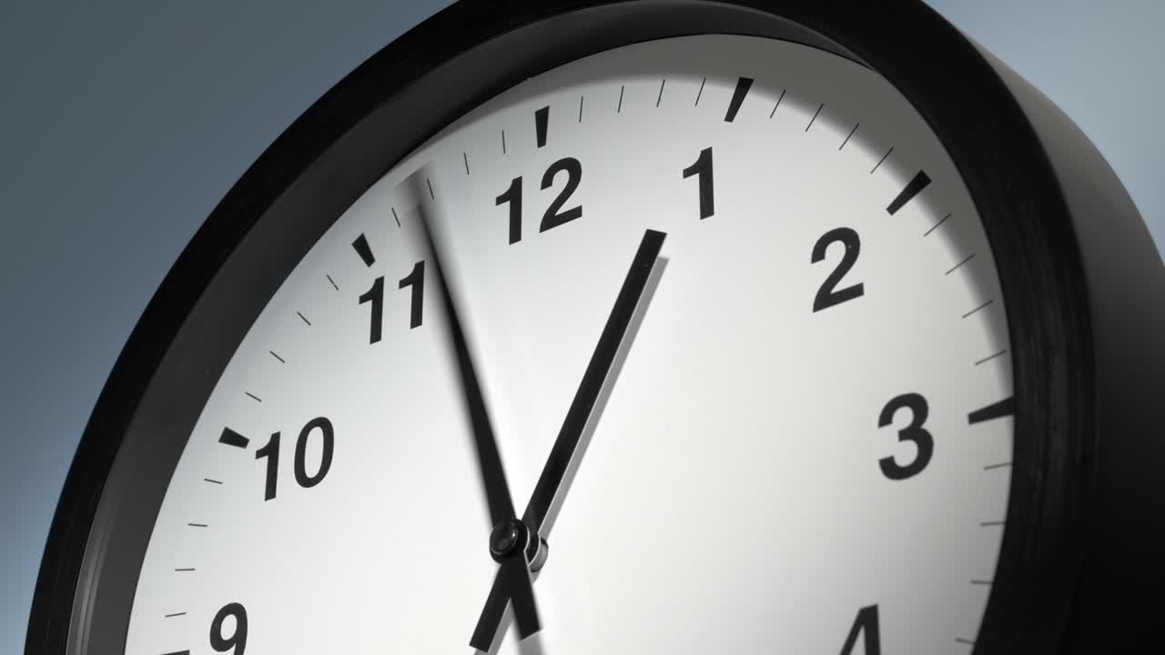 Clock Face on Light Blue Wall in Time Lapse