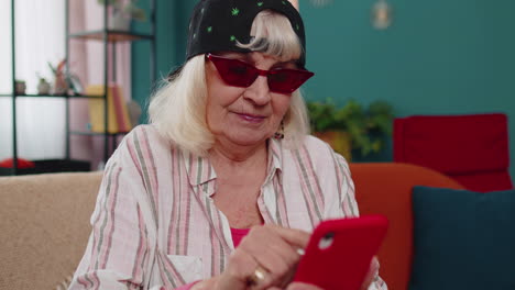 senior grandmother use mobile cell phone online shopping, found out great big win, celebrate at home