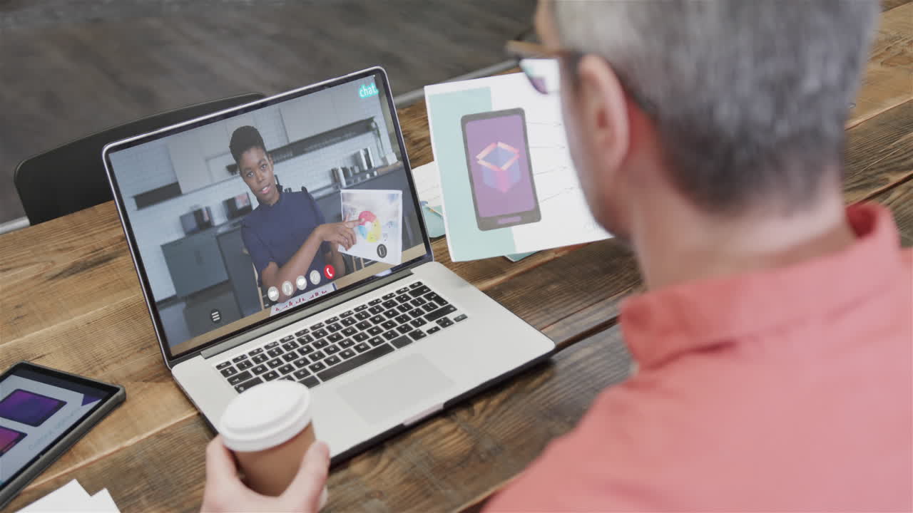 Caucasian businessman on laptop video call with african american female colleague on screen