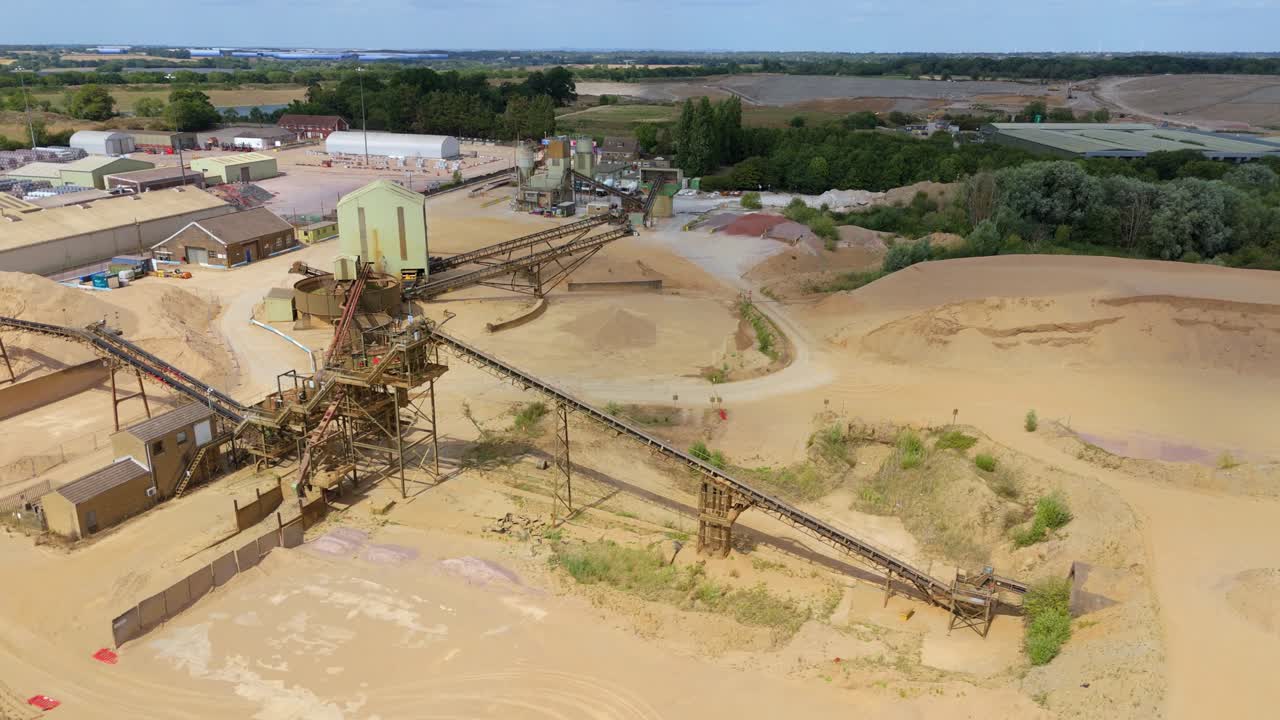 Aerial top down view of industrial aggregates site with mining equipment and machinery Rugby England UK