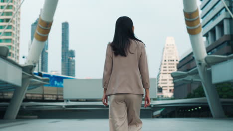 business woman walking in a modern city
