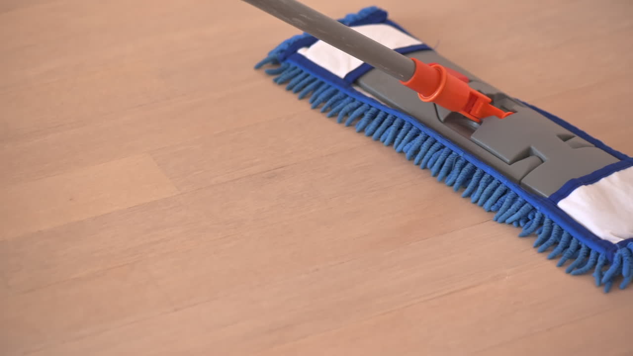 Close-up of a blue mop cleaning the floor