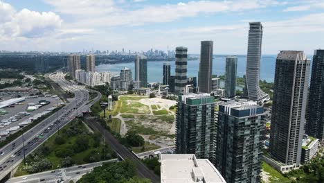 aerial shot of apartment buildings on the lakeshore of lake ontario with the gardiner expressway running past