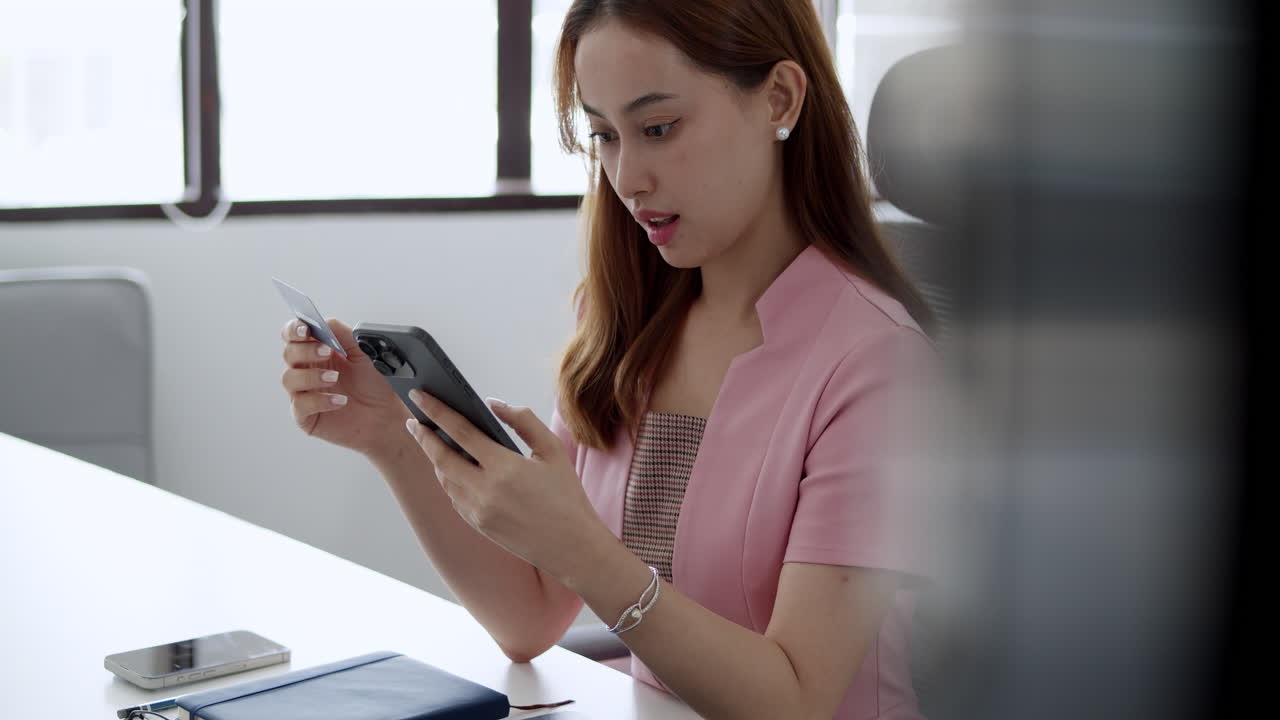 Mobile payment solutions young woman using phone office setting digital transaction modern workspace