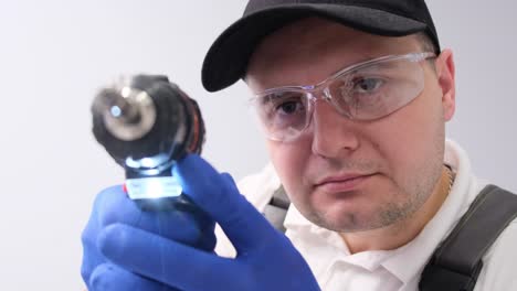 man with drill and safety glasses