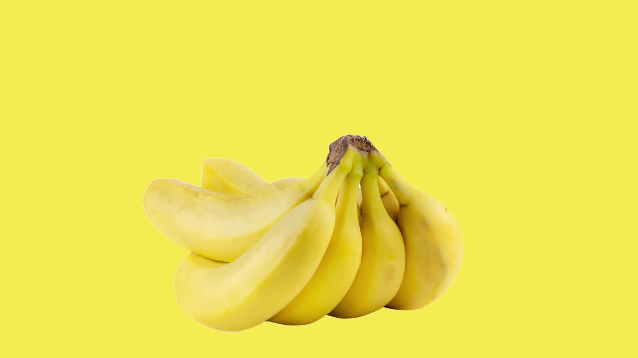 bunch of bananas animated on a yellow background closeup. seamless looping of realistic 3d food. minimal motion design art