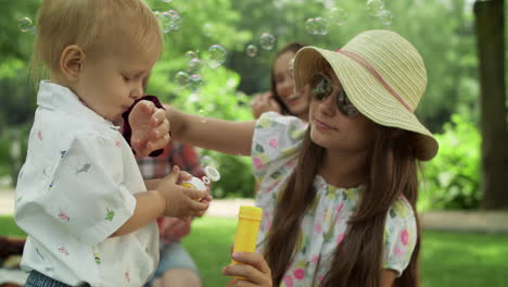 sister taking care of small brother in the park