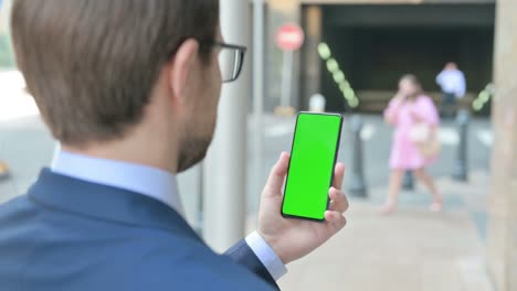 businessman using smartphone with green chroma screen