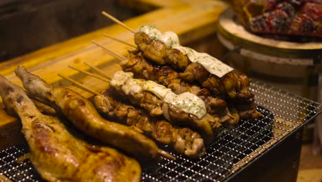 various meats and vegetables cooking on a grill