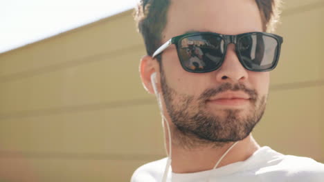 man wearing sunglasses and earphones