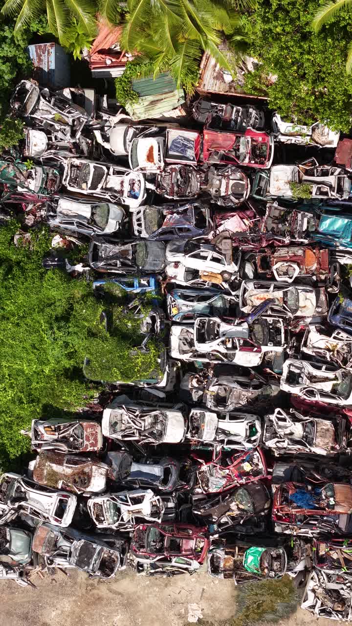 Vertical Drone Shot of Car Scrapyard on Bora Bora Island, French Polynesia. Birdseye Aerial View