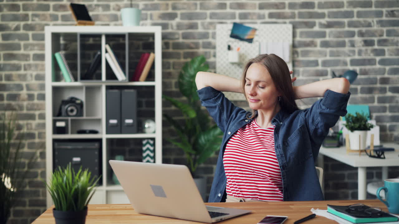 Woman Relaxing at Her Home Office Desk