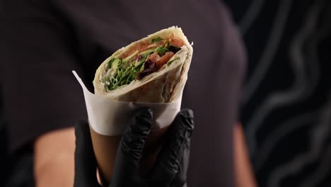 chef holding a delicious salmon wrap