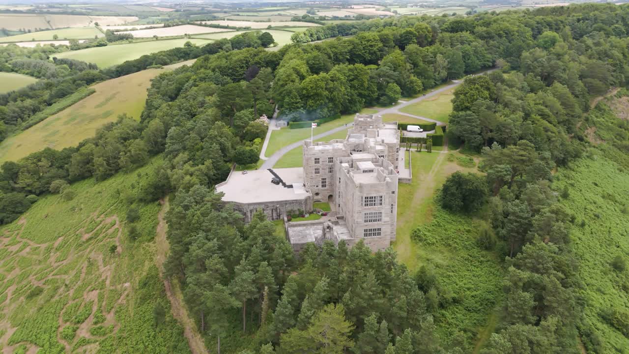 Aerial View of a Historic Castle Amidst Lush Green Forests