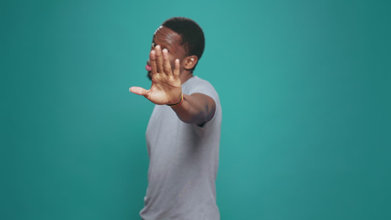 Portrait of person doing talk to the hand rejection gesture