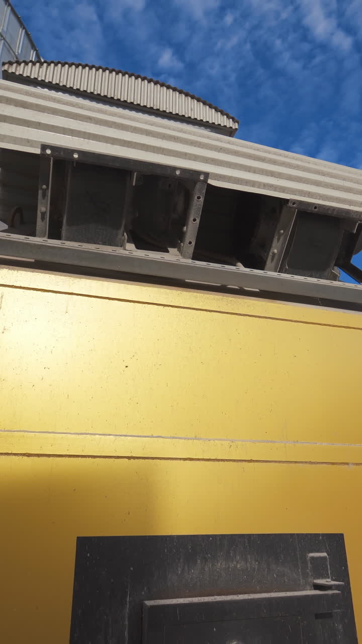 Large industrial plant with special equipment for processing crop. Industrial oven in the agricultural factory. Exterior of grain dryers farm. Vertical video