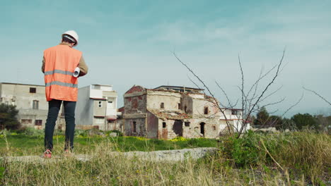 engineer in the nature looking at the building to remake