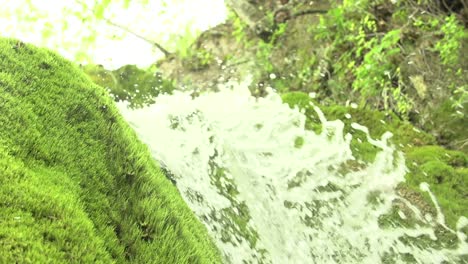 slow motion shot of a waterfall with moss and water drops, wasserfall dreimühlen, eifel