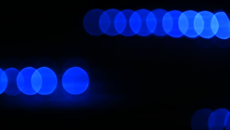 blue bokeh circles move over black background