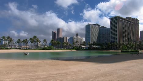 luxury buildings with palm trees and water surface in hawaii