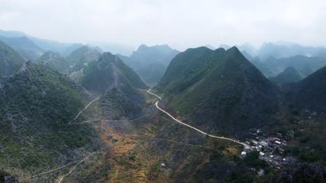 the majestic dong van plateau and the road to a small settlement, aerial