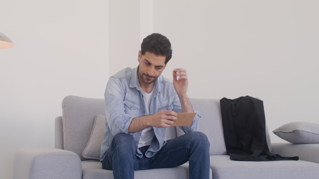 A Worried Man Holding An Envelope