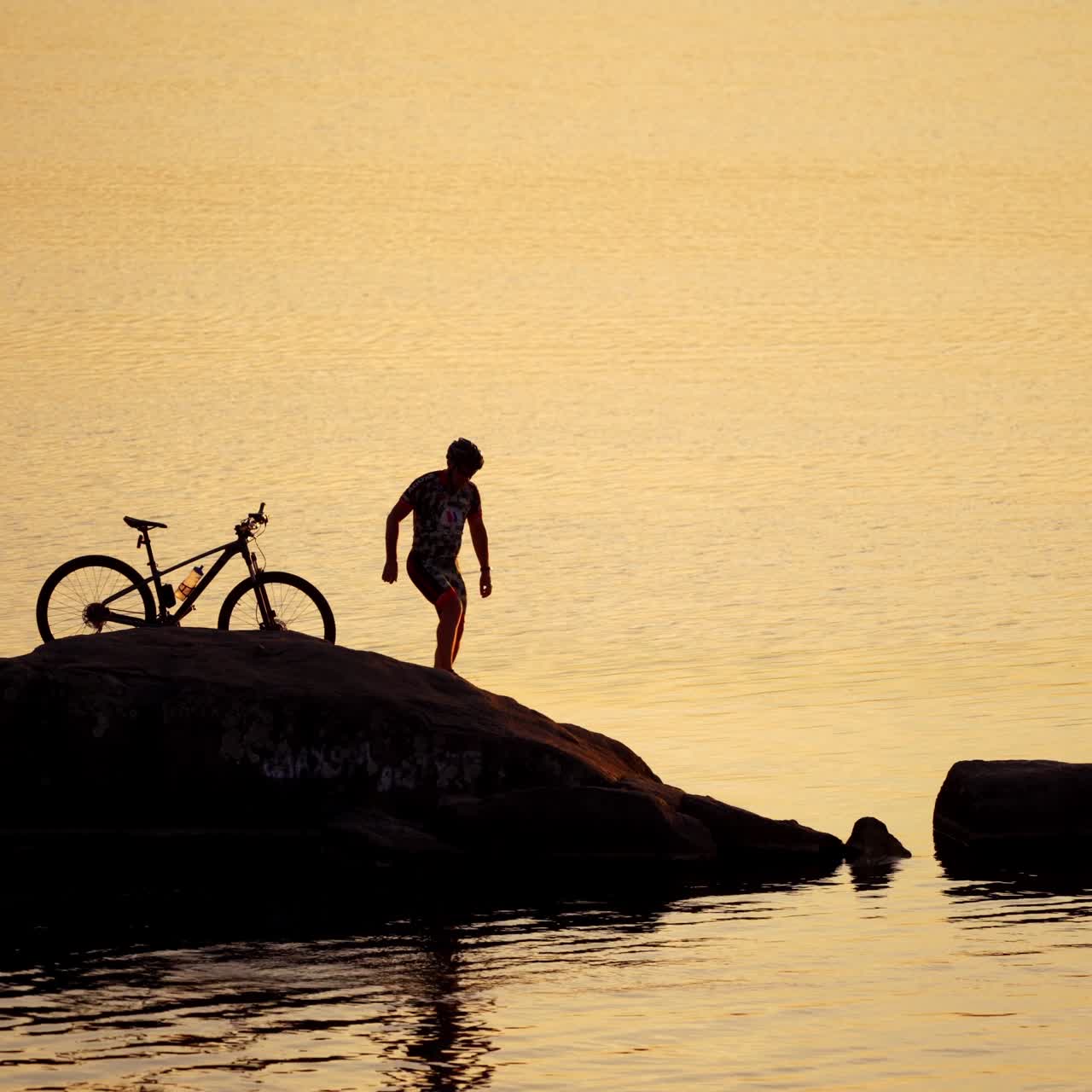 Sportive man with bicycle at sunset