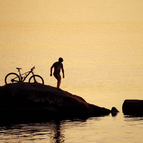sportive man with bicycle at sunset