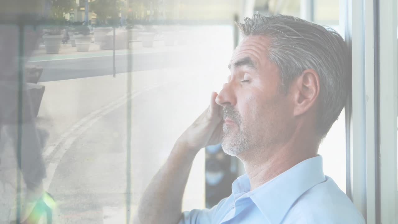Animation of caucasian businessman over people walking and cityscape