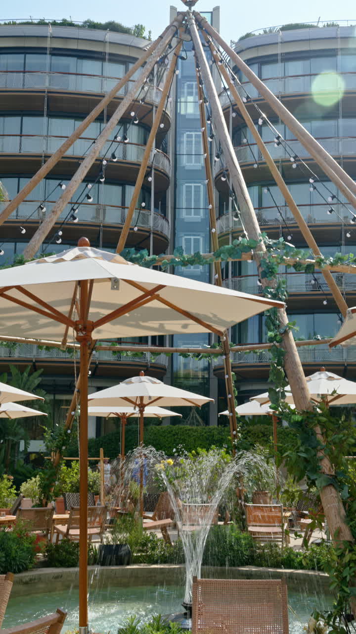 White umbrellas at a terrace in Monte Carlo, Monaco. Vertical