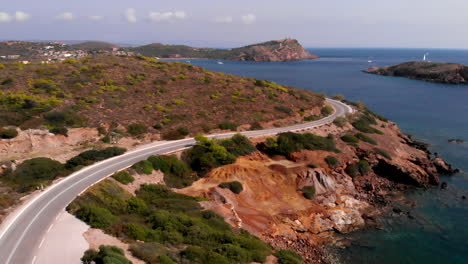 Auto-Verschwindet-Hinter-Kurve-Auf-Kurvenreicher-Straße-Am-Kap-Sounion,-Statische-Antenne