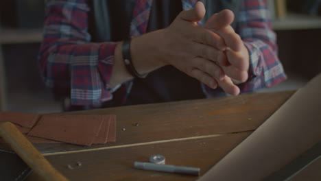 Worker-rubbing-hands-after-working-in-workshop.-Man-hands-ready-for-work