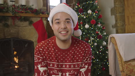 young man talking directly to camera during christmas video call