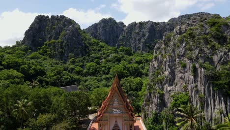 ascending footage revealing the staircase of the temple to the top, the limestone mountain with blue sky and clouds