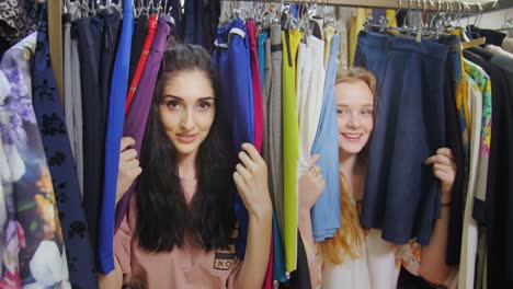 two happy women shopping for clothes