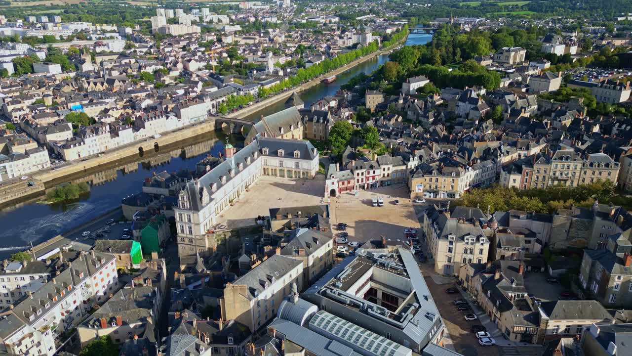 Drone shot pulling back over Laval showing Château Neuf, Mayenne River, old town and administrative building