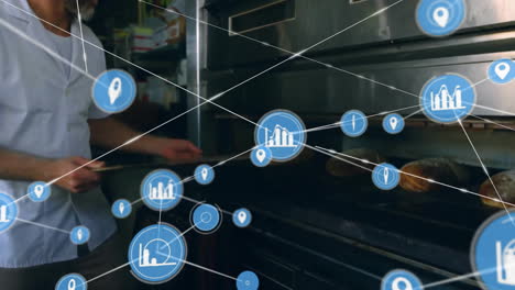 Animation-of-network-of-connections-with-icons-over-caucasian-baker-in-kitchen