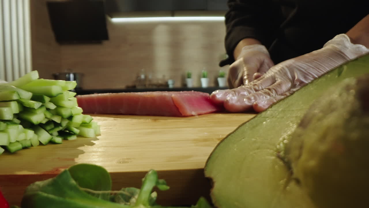 Close-up of Chef's Hands Preparing Fresh Ingredients and Slicing Tuna
